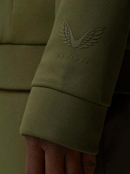 Castore wing logo and wordmark embossed on an olive green sleeve