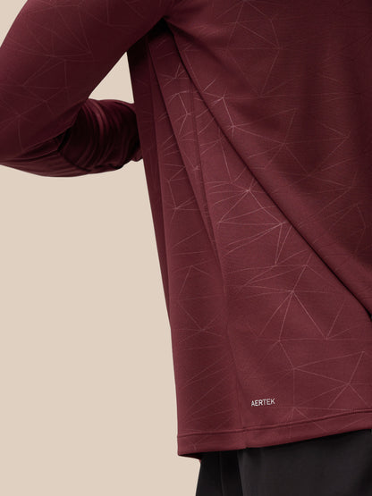 Close-up of plum Adapt Training fabric with geometric lines and AERTEK branding.
