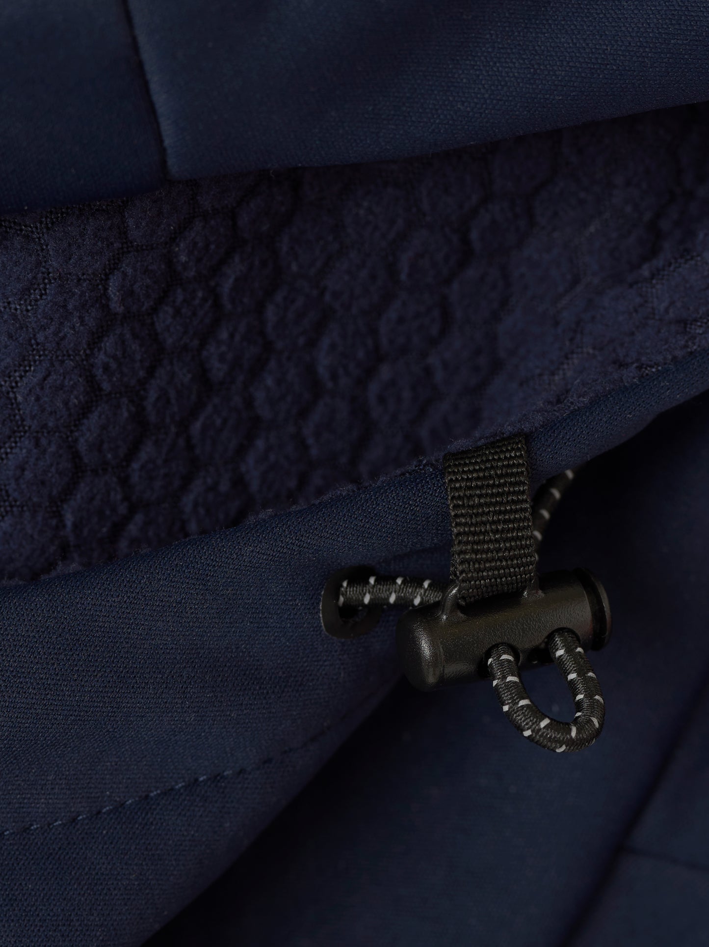 Close-up of navy Garcia 3.0 Hoodie interior showing quilted lining and drawcord adjuster.