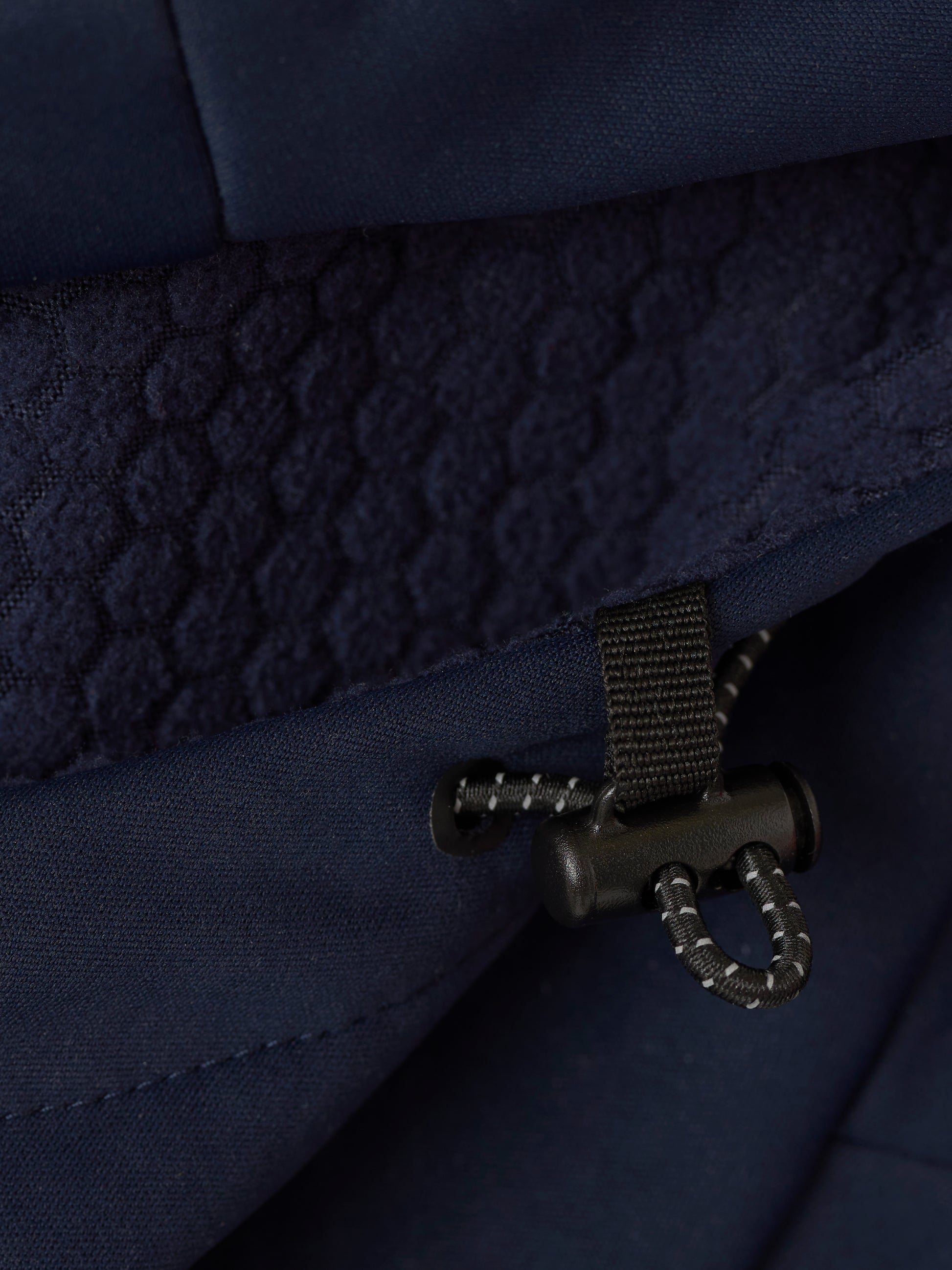 Close-up of navy Garcia 3.0 Hoodie interior showing quilted lining and drawcord adjuster.