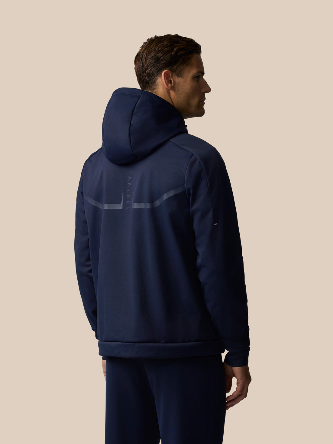 Rear view of navy Garcia 3.0 Hoodie on a man with hood up and a reflective back stripe.