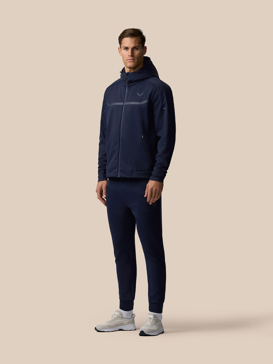 Male model wearing navy Garcia 3.0 Hoodie with full front zip and adjustable hood, paired with matching joggers.