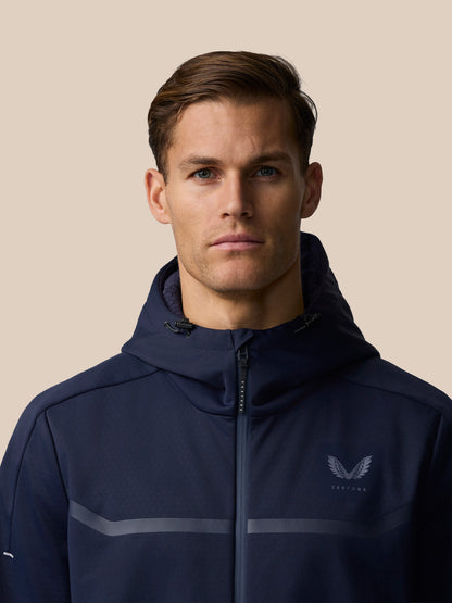 Front view of male model wearing navy Garcia 3.0 Hoodie with hood down and chest logo.