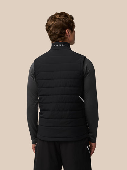 Back view of a man in a black Apex Training Gilet with Castore wordmark on the back collar