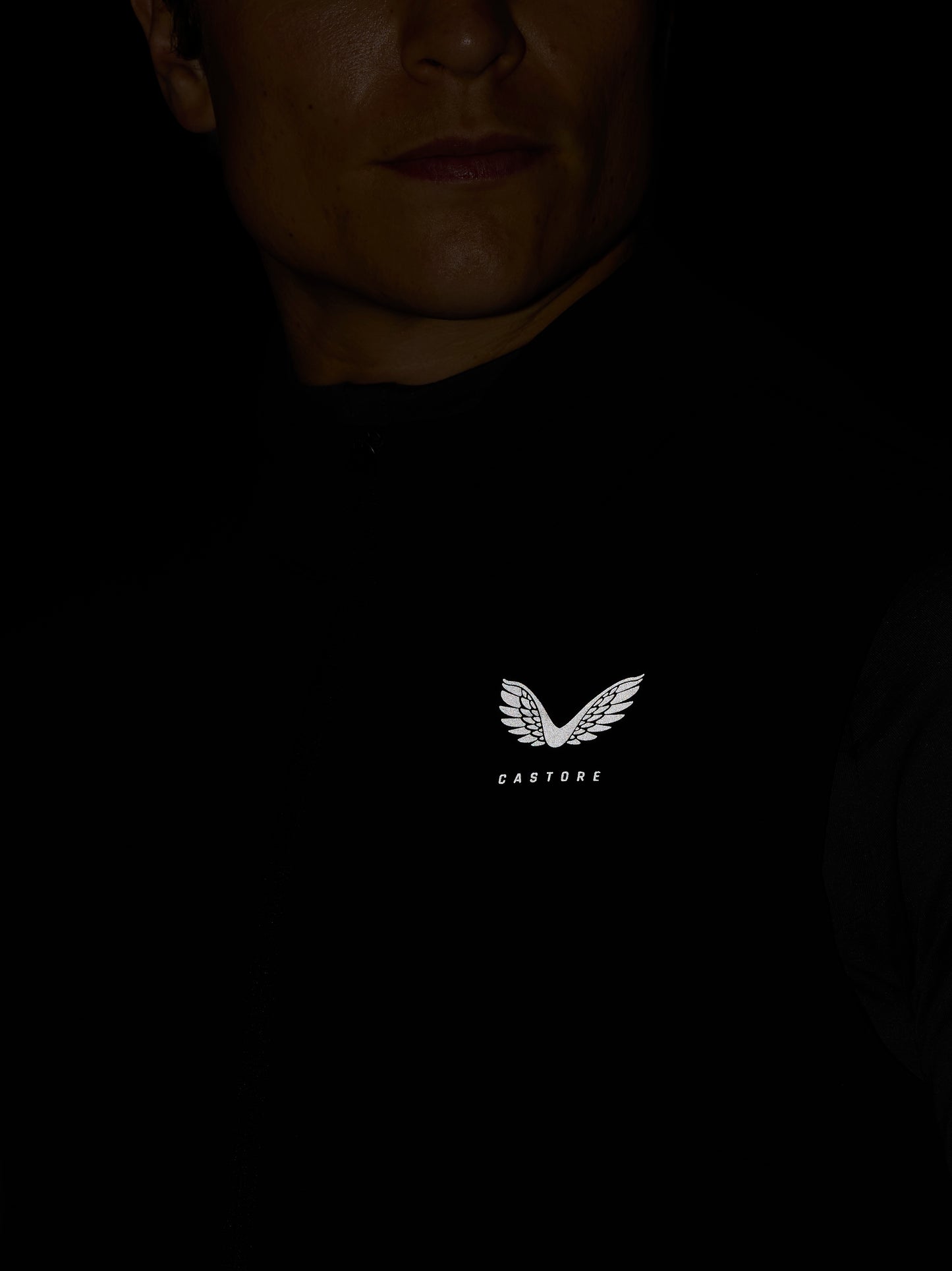 Model wearing black Apex Training Gilet with Castore logo and wing emblem visible on the chest area