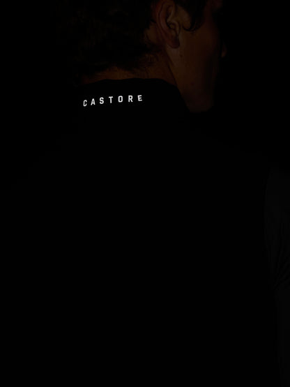 Back of neck close up on black Apex Gilet showing Castore branding on the zipper pull