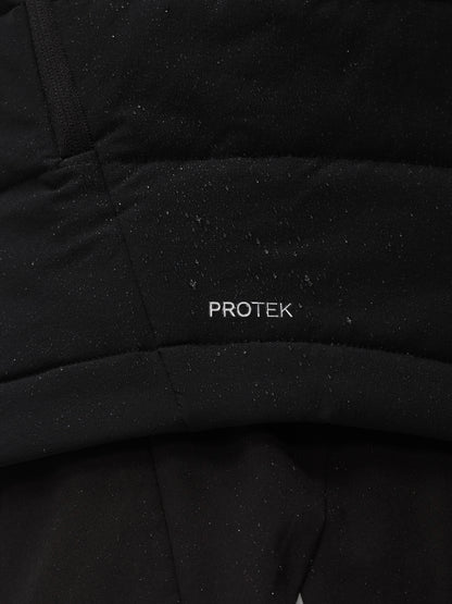 Close up of black Apex Training Gilet fabric with ProTek label and seam details