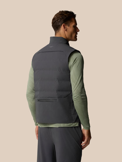 Back view of a man wearing Zone Training LVS Insulated Gilet in gunmetal gray sleeveless vest over a green top
