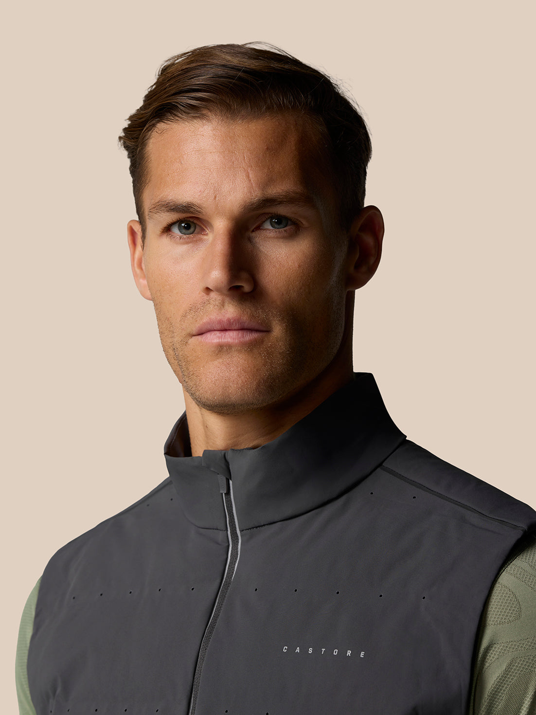 Close up of Zone Training LVS Insulated Gilet showing front zipper and CASTORE branding on chest