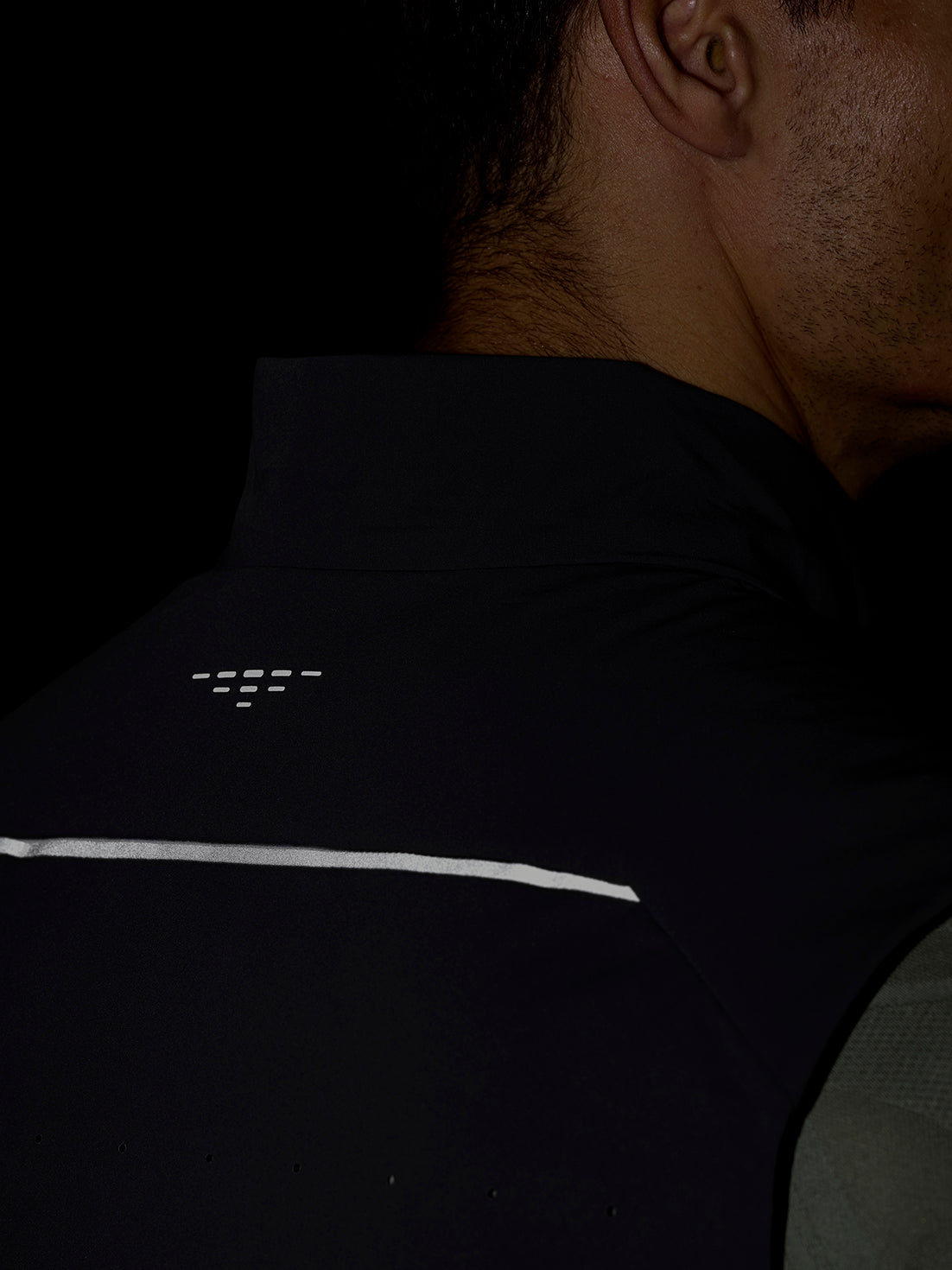 Back view of Zone Training LVS insulated gilet in gunmetal black with reflective back detail