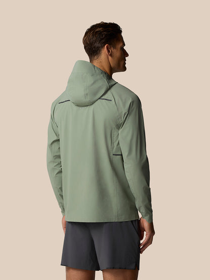 Back view of Zone Training LVS Jacket in Thyme with hood up and layered ventilation back identifier