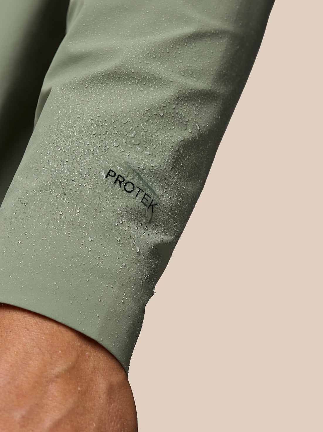 Sleeve close up showing ProTek branding and water droplets on the fabric
