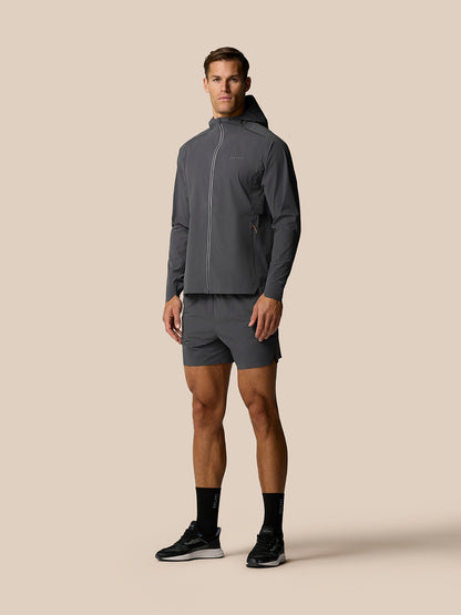 Male model in Zone Training LVS Jacket in gunmetal gray with hood down front view