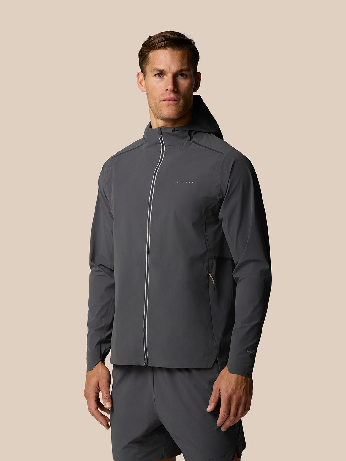 Male model wearing Zone Training LVS Jacket in gunmetal gray with hood and full front zip