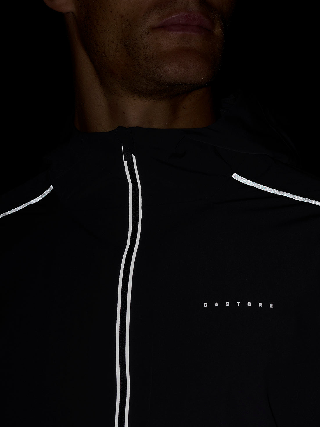 Front view of Zone Training LVS Jacket in gunmetal gray featuring dual white reflective piping along the zipper and CASTORE branding on the chest.
