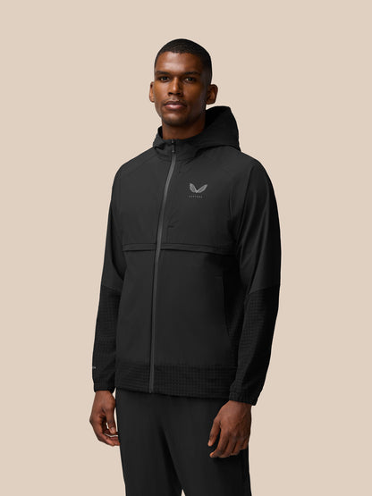 Side profile of a man wearing black Flex Winterised Woven Jacket with hood and front zipper