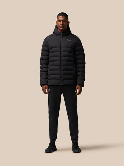 Three-quarter front view of a man in a black puffer jacket with hood and zip details