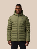 Man wearing ivy green lightweight puffer jacket with hood and front zipper, logo on chest, against a beige backdrop.