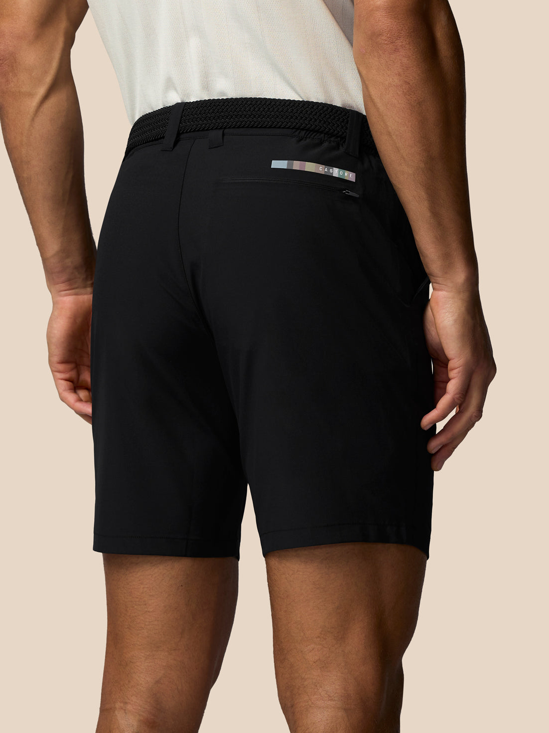 Back view of black Castore x Paul Smith golf shorts showing logo strip above back pocket