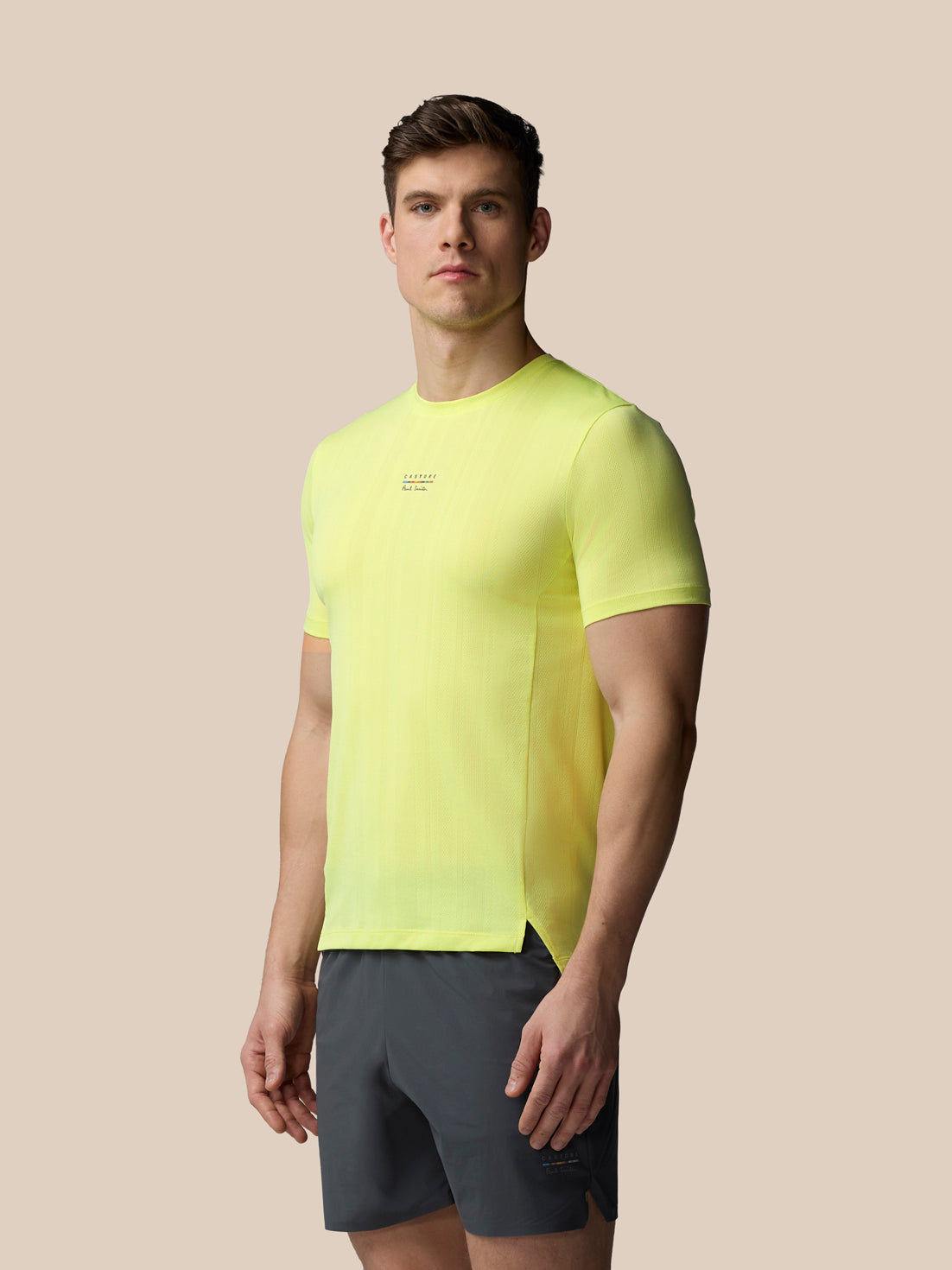 Male model in lime neon knit short sleeve T shirt featuring Paul Smith branding at the chest
