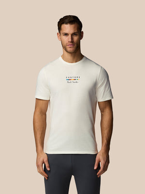 Man wearing a white t-shirt with a logo on a beige background