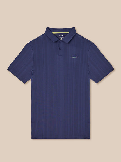 Navy knit polo with pointed collar and button placket featuring Castore x Paul Smith branding on the chest.