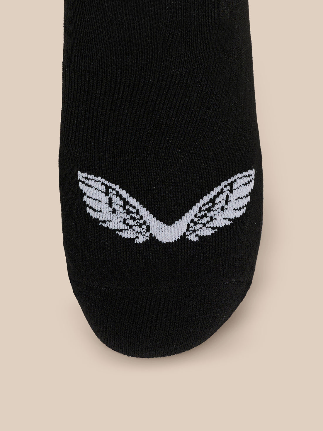 Close up of black ankle sock displaying a white wing logo at the midfoot
