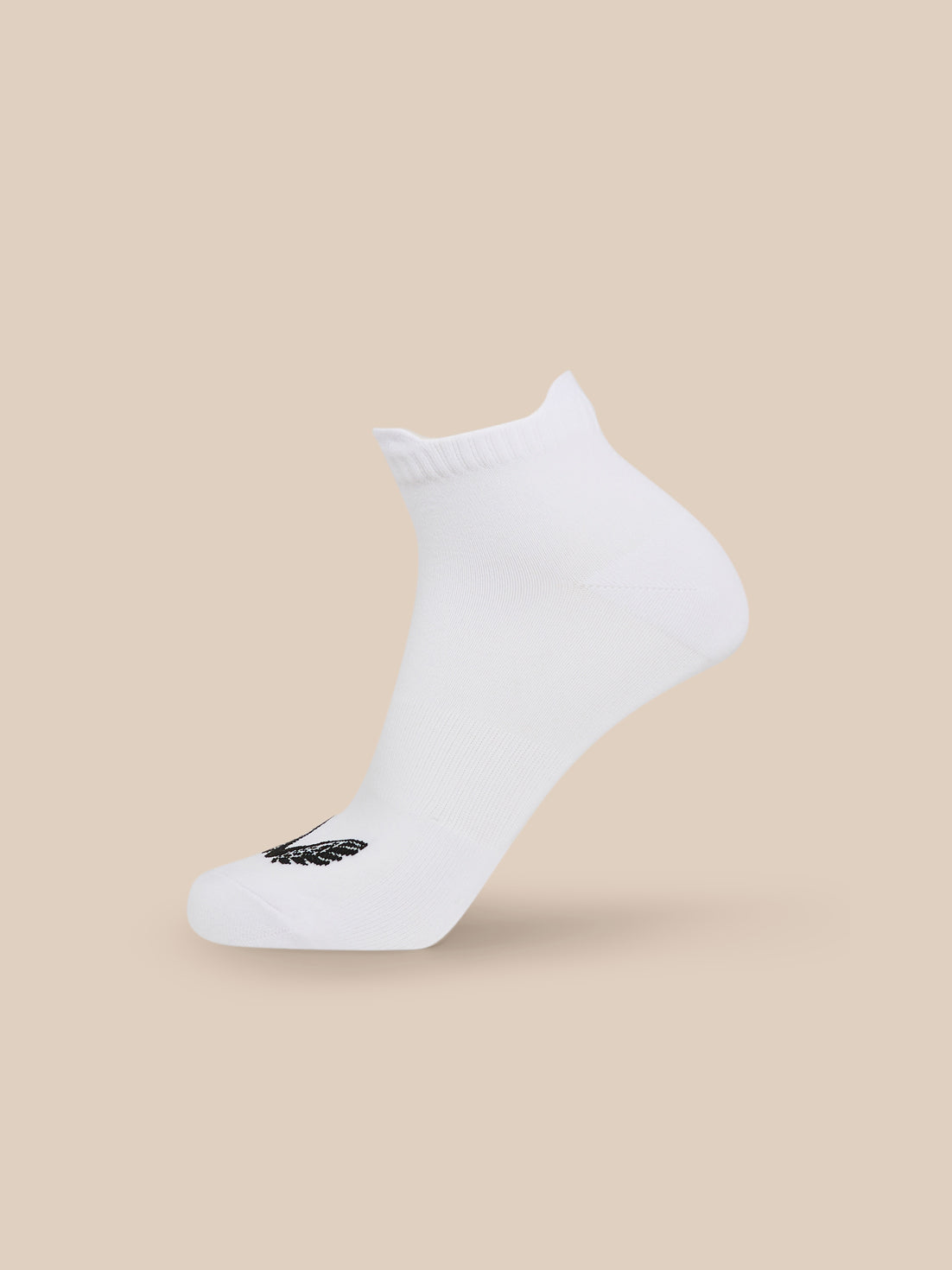White ankle sock with a black wing logo near the toe on a beige background