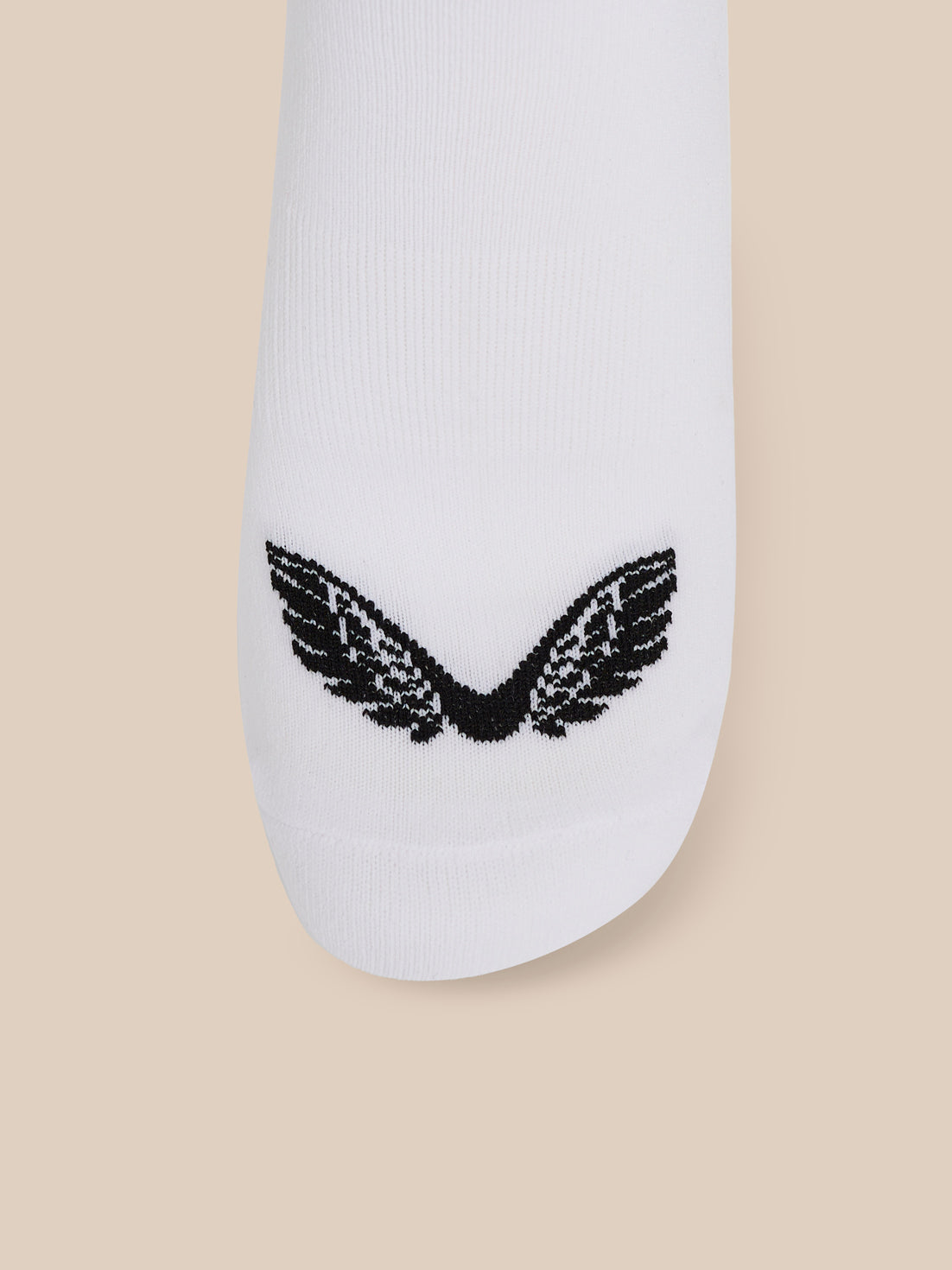 Close-up of a white ankle sock showing the black wing logo at the toe from a different angle