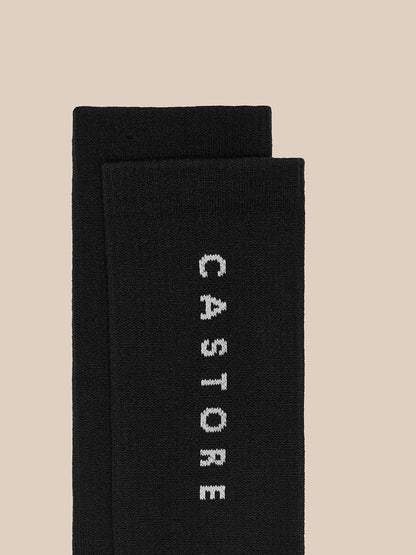 Close up of a black Castore crew sock with vertical CASTORE branding along the leg.