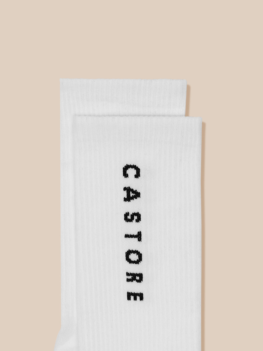 Two white crew socks folded with Castore branding visible.