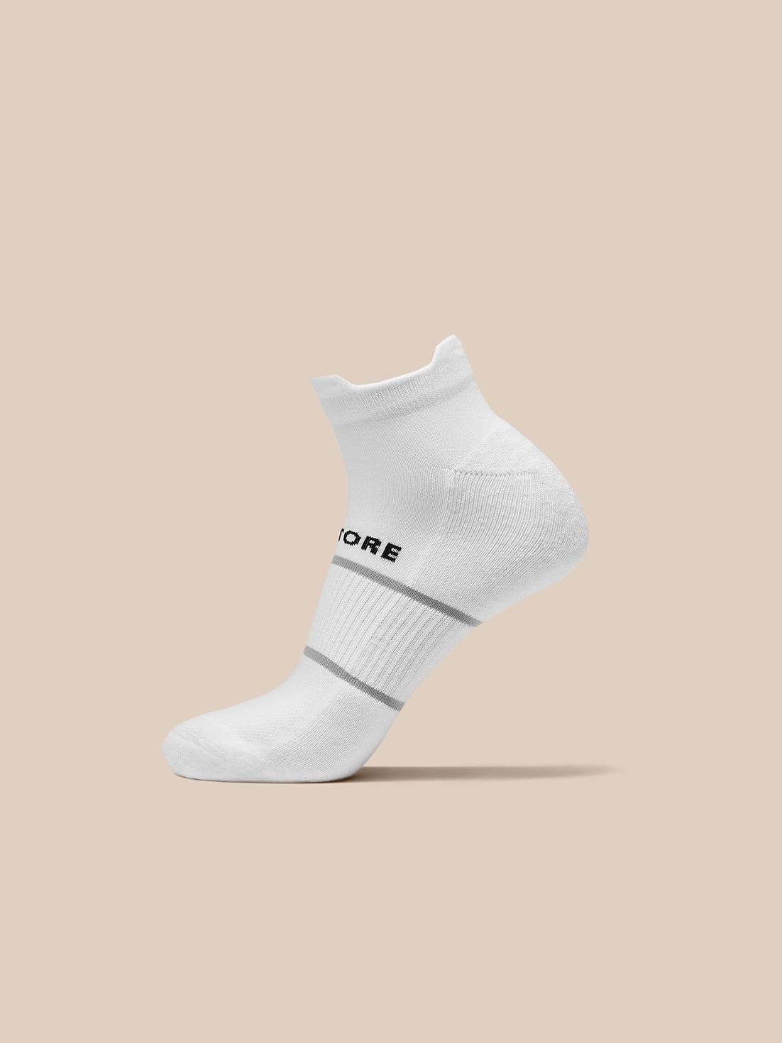 White ankle sock from the 3 Pack with Castore branding and ribbed cuff displayed on a beige background