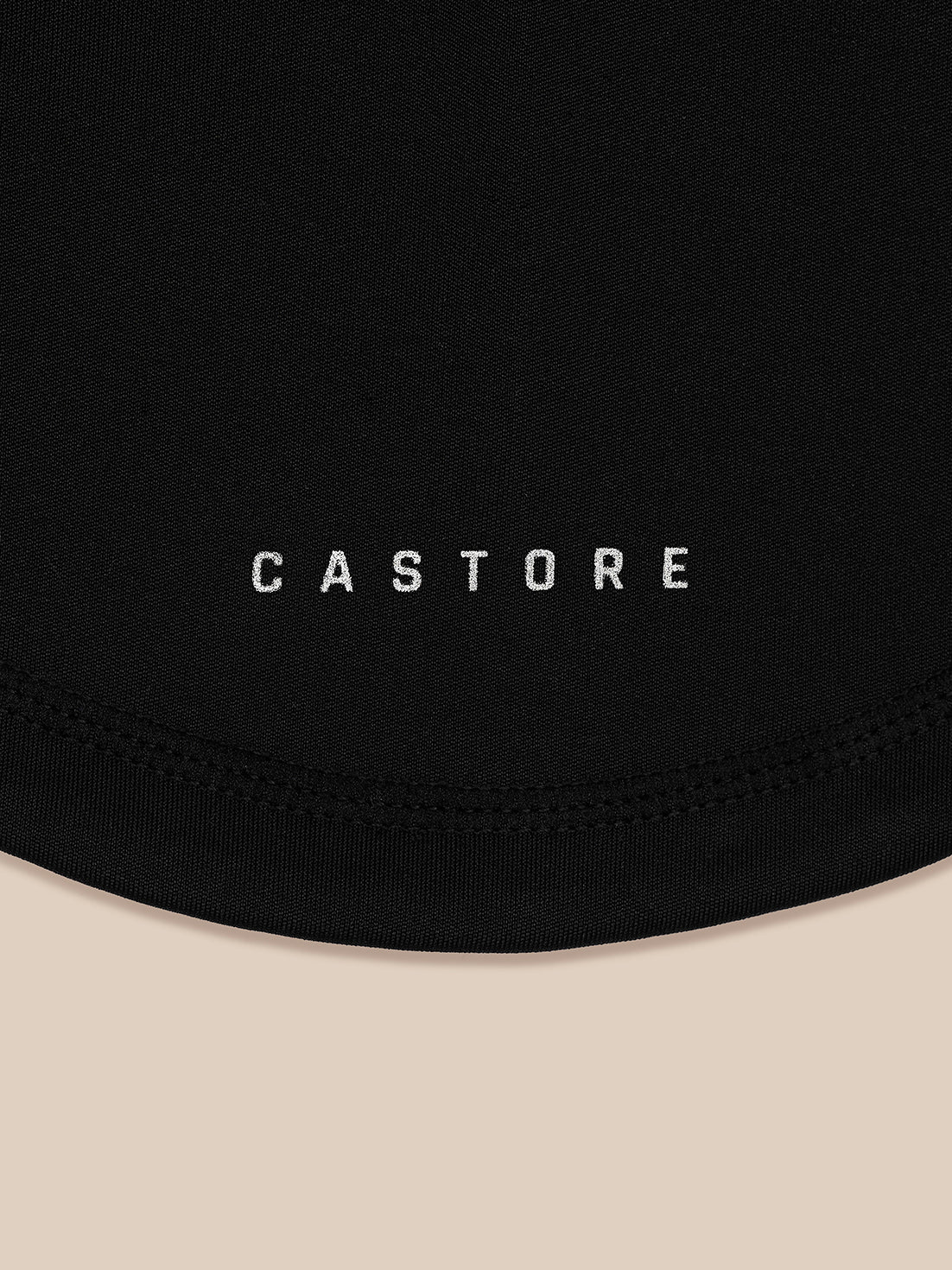 Close-up of black snood fabric with Castore branding visible.
