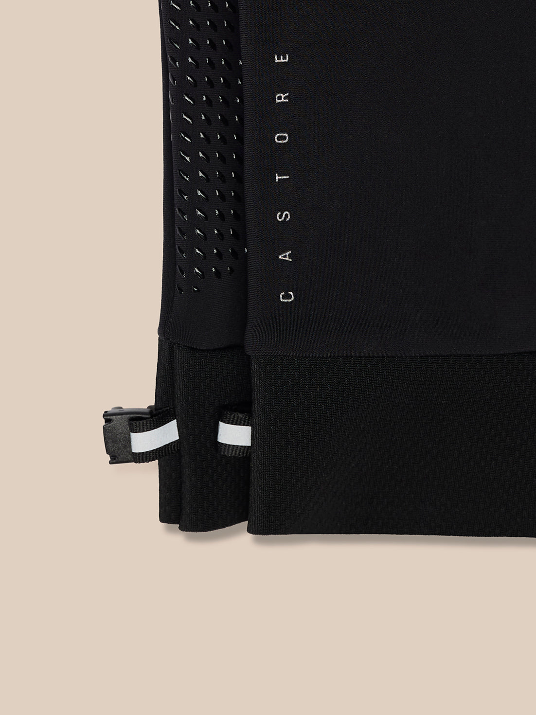 Close-up of black Pursuit glove showing mesh wrist panel and reflective Castore wordmark