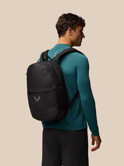 Man wearing a teal long sleeve shirt carries a black Active Backpack on his back.