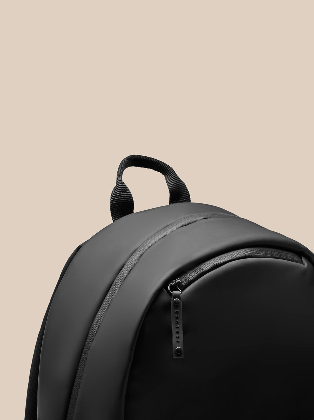Close up of the curved top and strap detail on the black Active Backpack for comfortable daily wear.