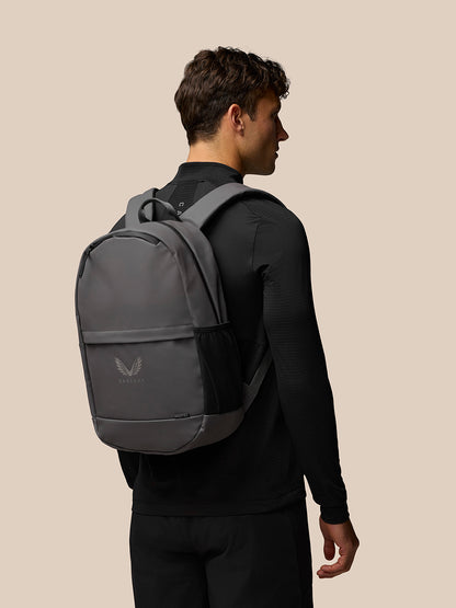Person in profile wearing the charcoal Active Backpack on the back, showing gray polyurethane body and padded straps