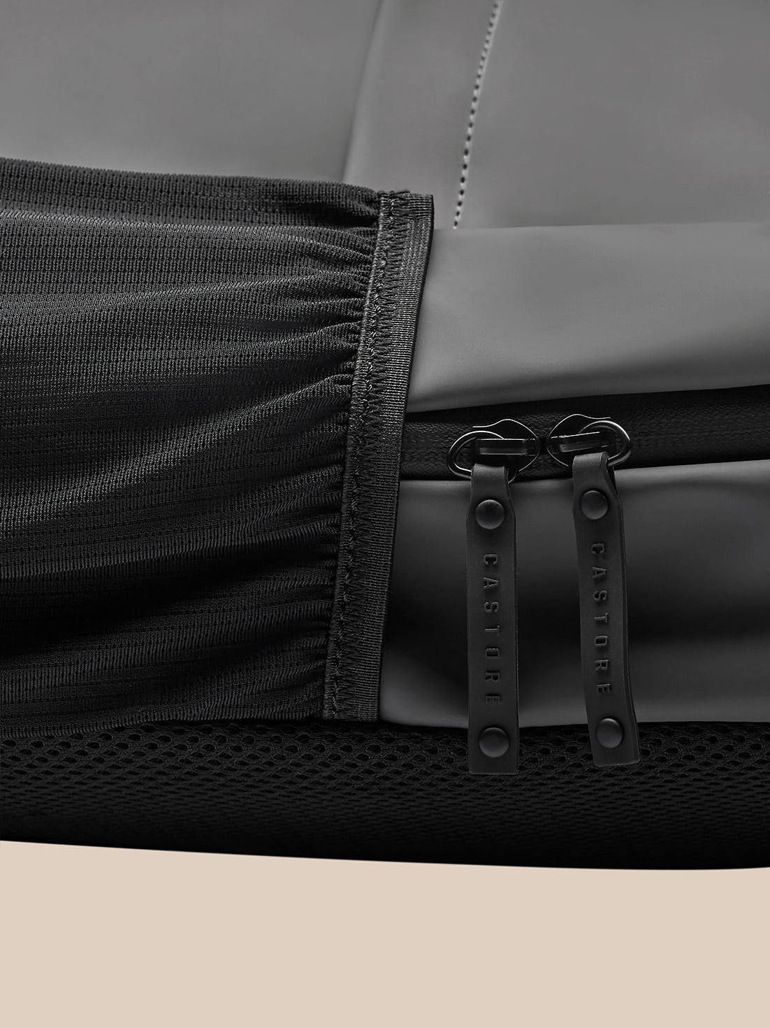 Close up of charcoal Active Backpack zipper area with double pulls and textured polyurethane fabric