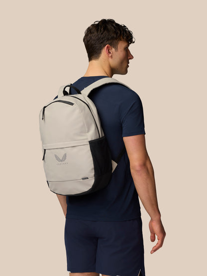 Model wearing Active Backpack Rock Grey on the back with navy clothing