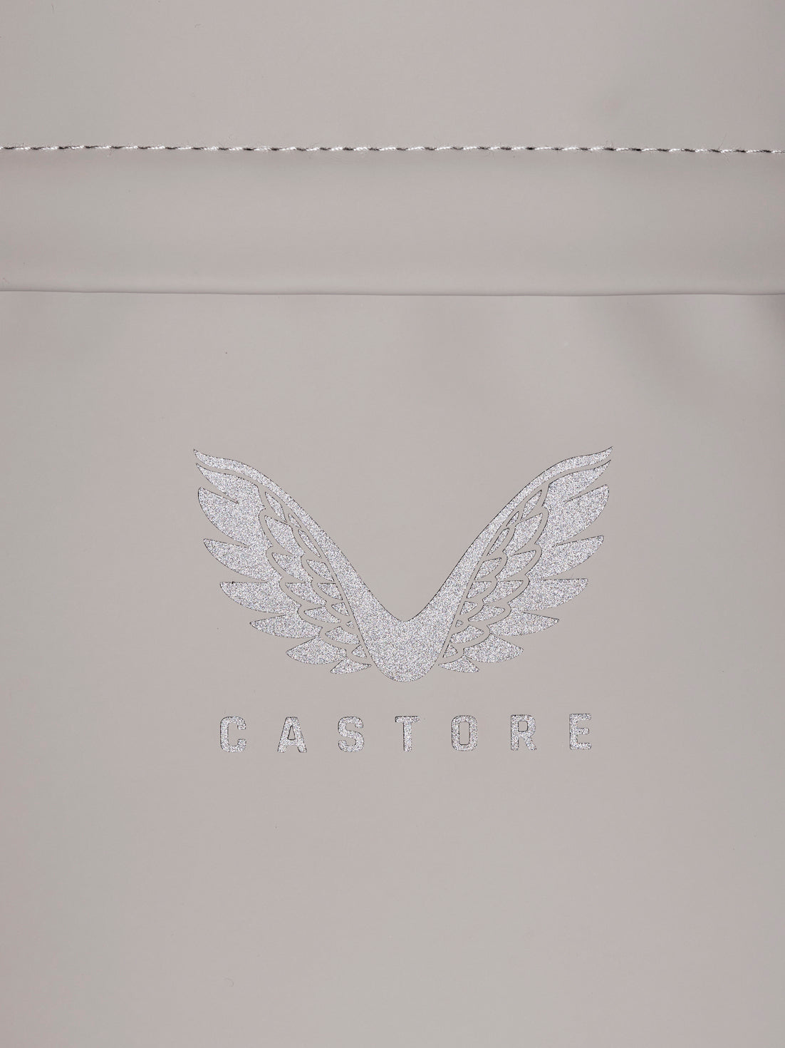 Close up of CASTORE zipper pulls on beige backpack edge