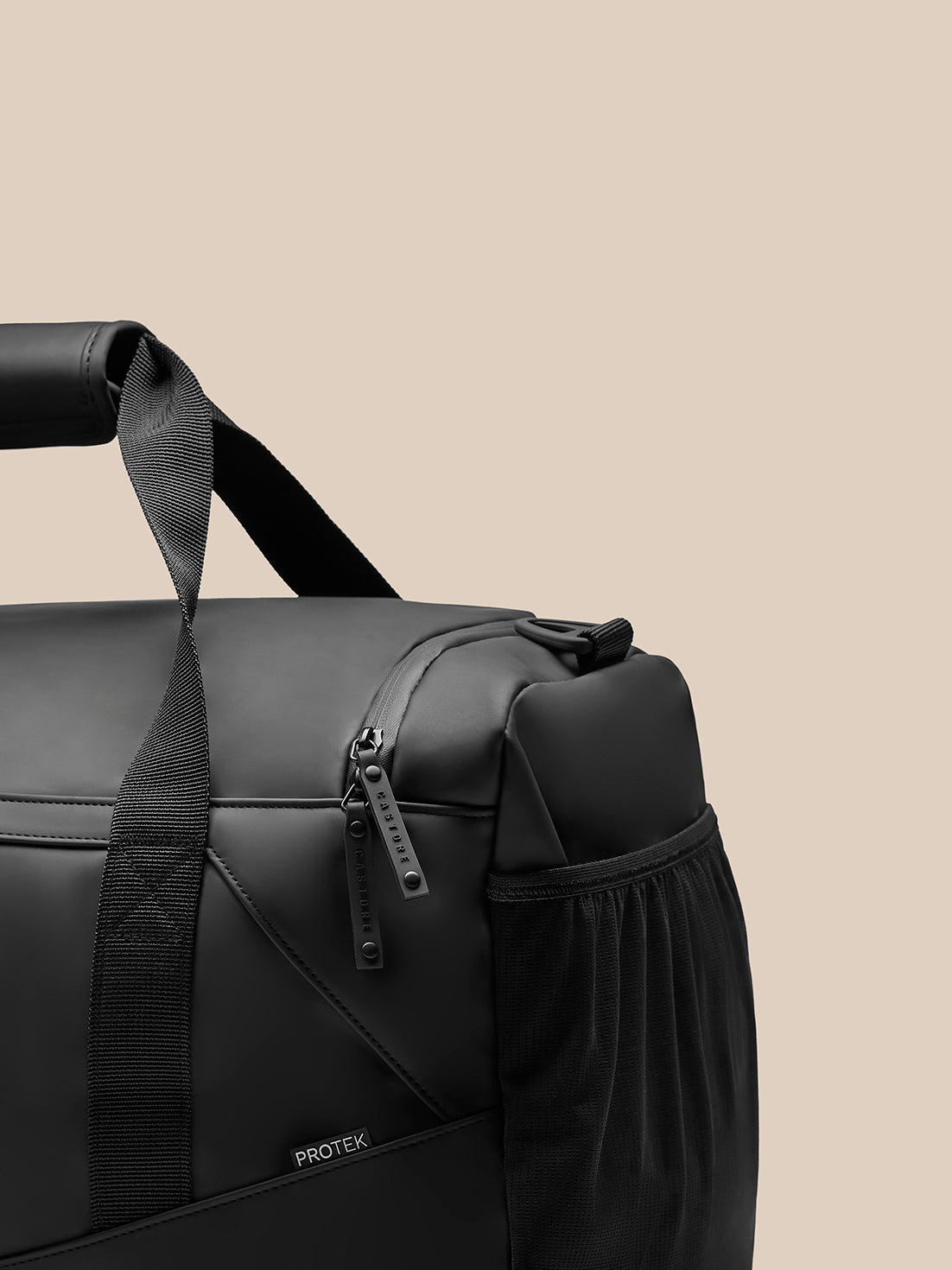 Close up of a black holdall showing zipper pulls and ProTek branding