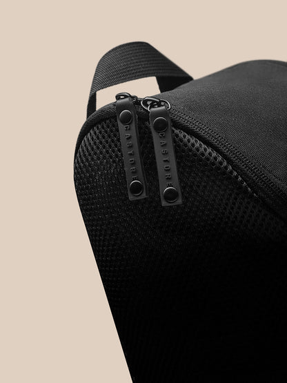 Close-up of top edge with carry strap and zipped closure on the black Boot Bag.