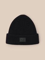 Black ribbed beanie with folded cuff and Castore logo patch on front.