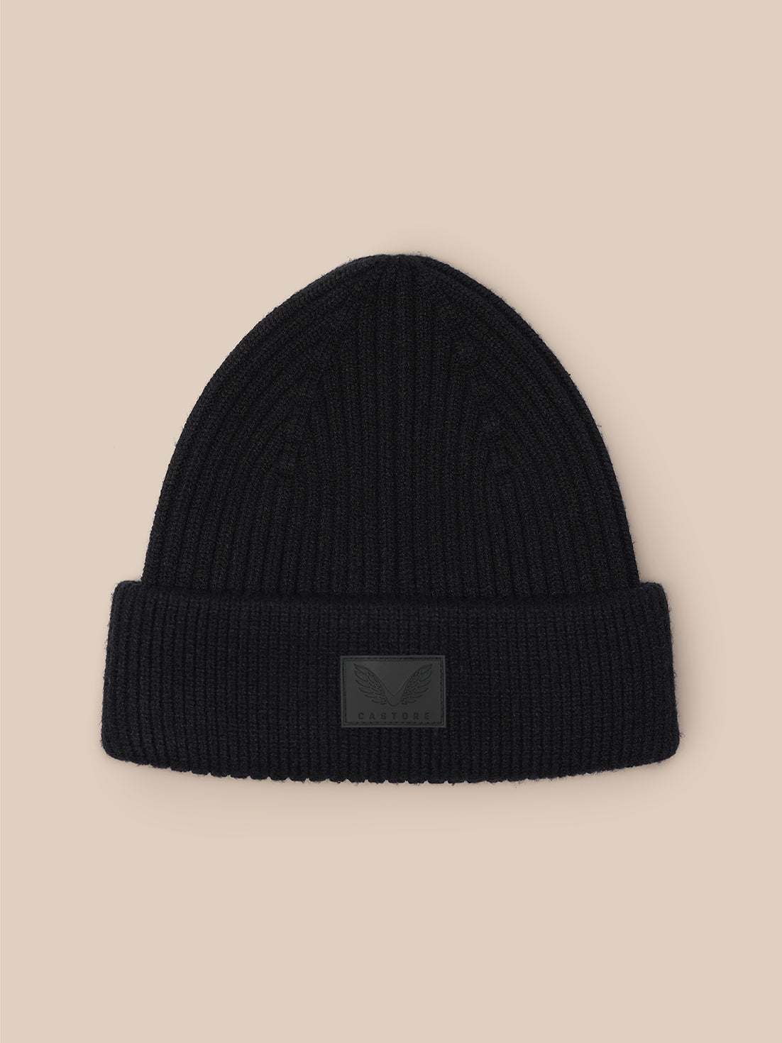 Black ribbed beanie with folded cuff and Castore logo patch on front.