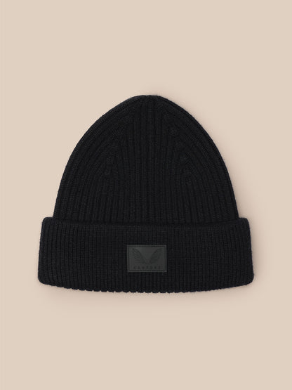 Black ribbed beanie with folded cuff and Castore logo patch on front.