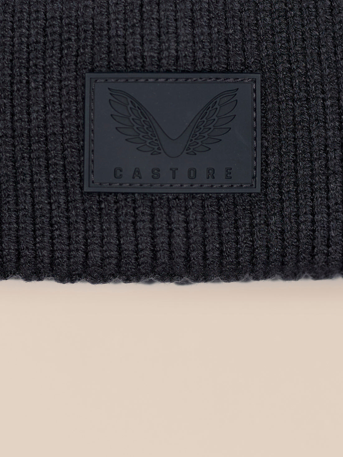 Beanie focusing on knit texture with folded cuff and Castore patch