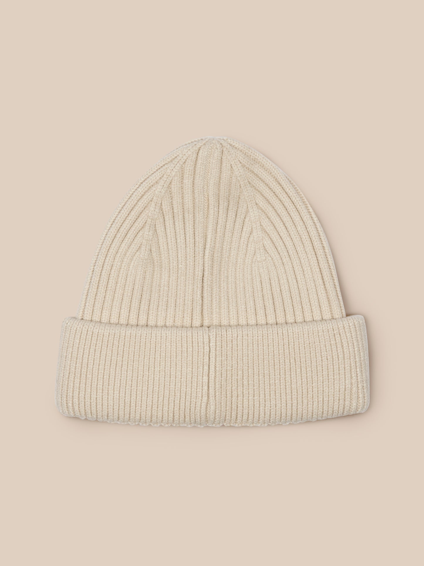 Stone colored ribbed knit beanie with Castore logo on the foldover