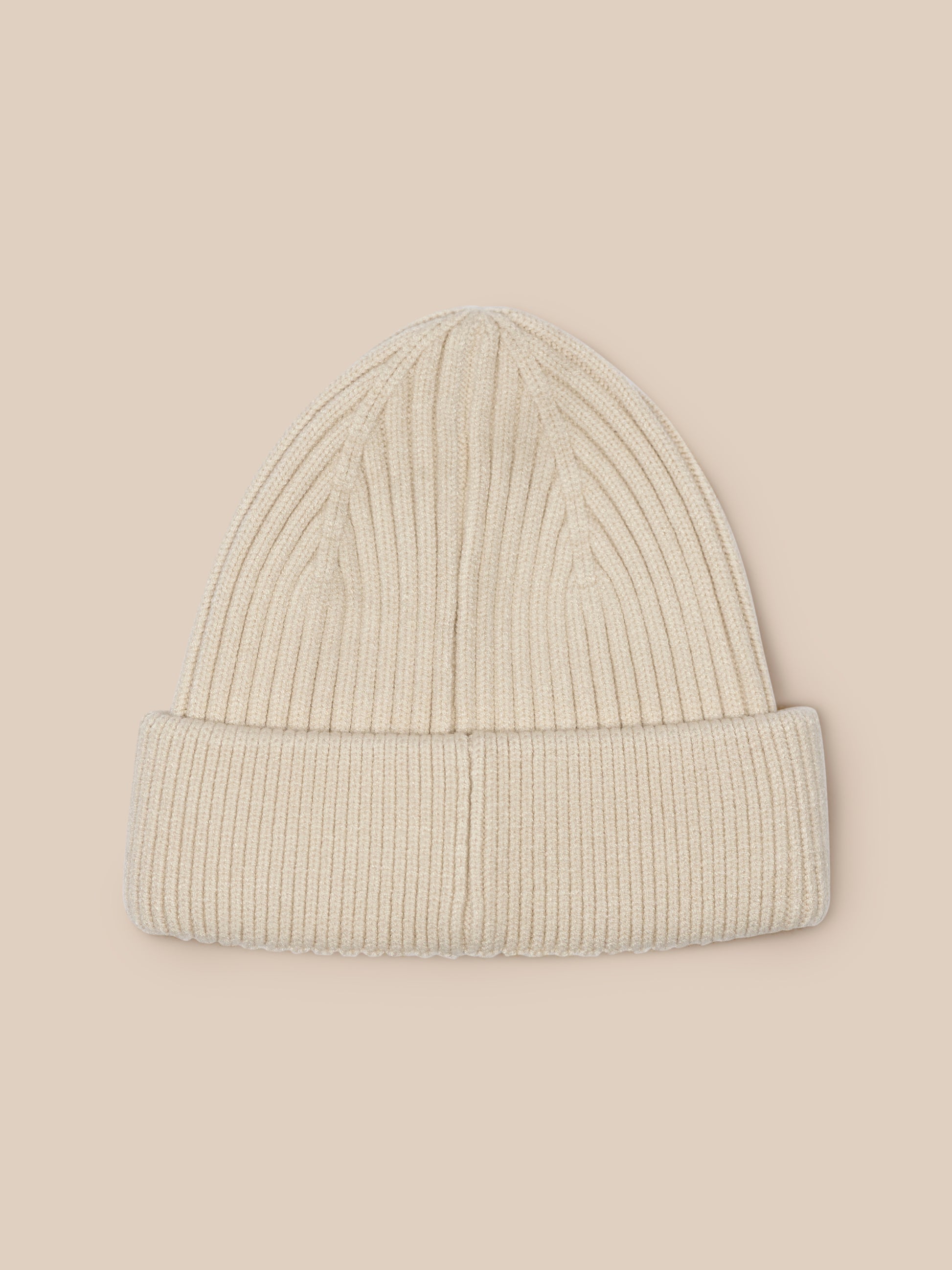 Stone colored ribbed knit beanie with Castore logo on the foldover