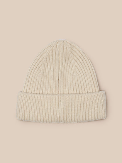 Stone colored ribbed knit beanie with Castore logo on the foldover