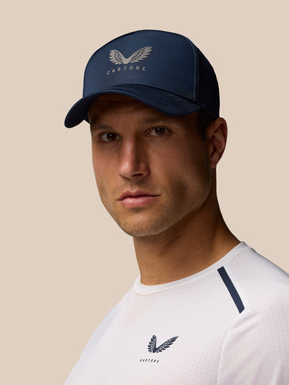 Male model wearing navy Active Cap with Castore logo, halo eyelets and back adjuster.
